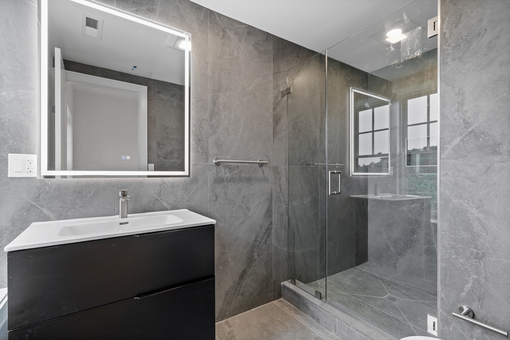 1578 Beacon Street, Unit 202 Brookline, MA 02446 - Photo 11 of 18 a bathroom with a sink and a mirror