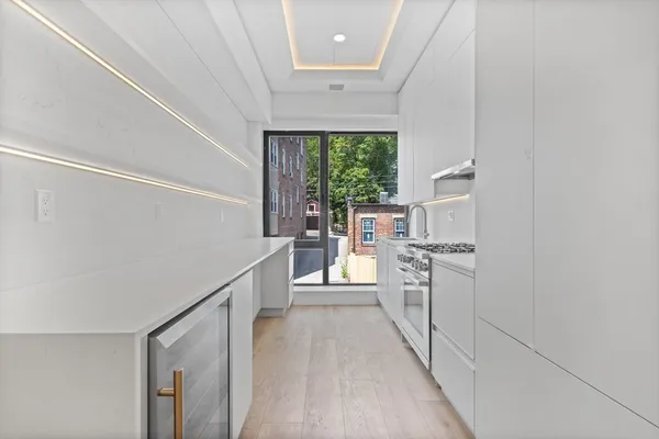 a kitchen with white cabinets and white appliances