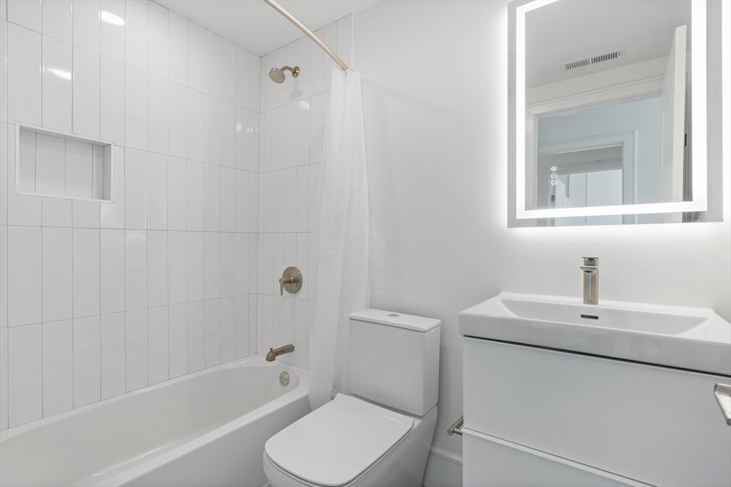 1578 Beacon Street, Unit 202 Brookline, MA 02446 - Photo 8 of 18 a bathroom with a sink toilet and shower