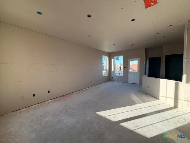 a view of an empty room with windows