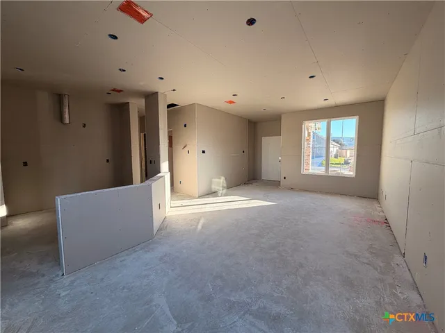 an empty room with windows and entrance