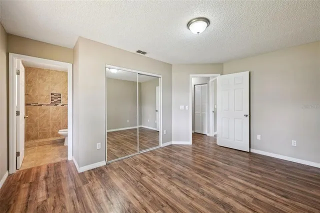 a view of a room with wooden floor and bathroom