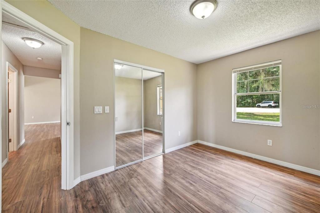 5 Cedar Lane Ocala, FL 34472 - Photo 16 of 24 wooden floor in an empty room with a window