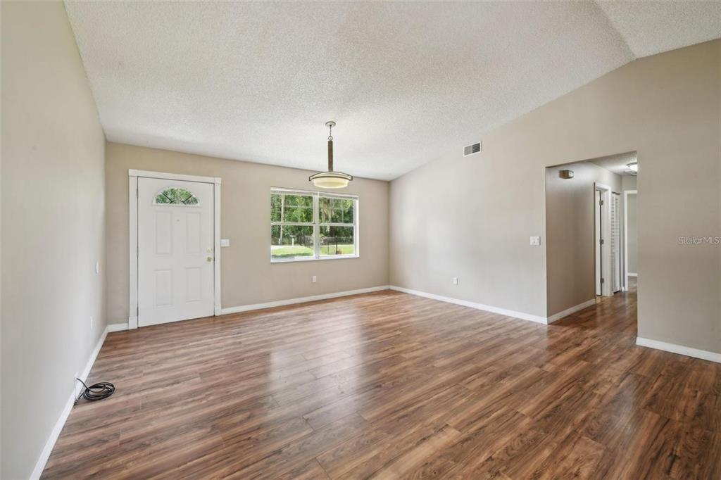 5 Cedar Lane Ocala, FL 34472 - Photo 5 of 24 wooden floor in an empty room with a window