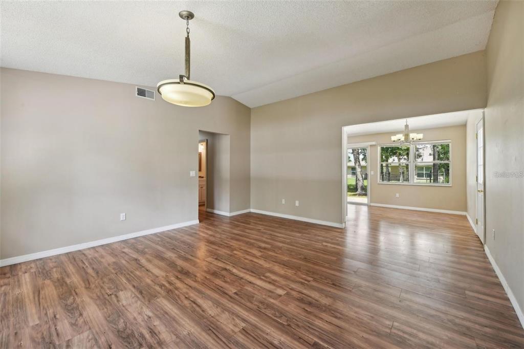 5 Cedar Lane Ocala, FL 34472 - Photo 6 of 24 a view of an empty room with wooden floor and a window