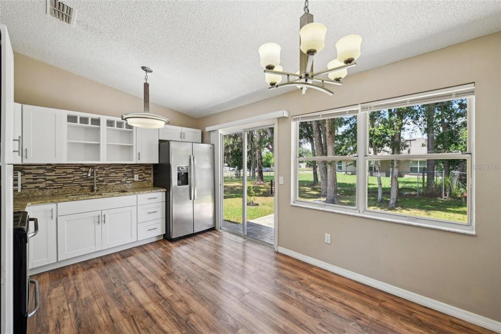 5 Cedar Lane Ocala, FL 34472 - Photo 9 of 24 a kitchen with stainless steel appliances granite countertop a refrigerator a oven a stove and a wooden floors