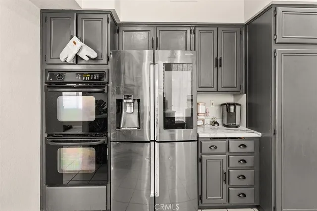 a kitchen with kitchen island a counter top space cabinets and stainless steel appliances