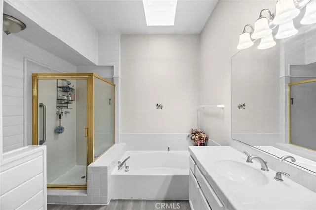 a bathroom with a tub a sink and a mirror