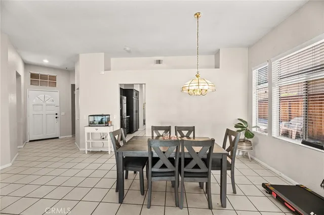 a view of a dining room with furniture and chandelier