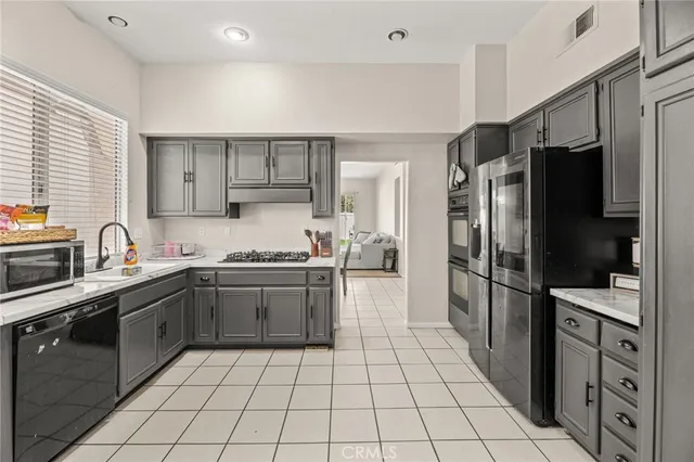 a kitchen with stainless steel appliances granite countertop a refrigerator and a sink