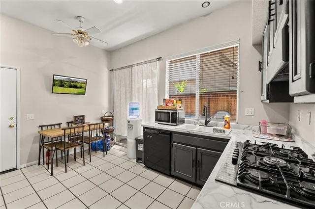 a kitchen with a sink appliances and cabinets