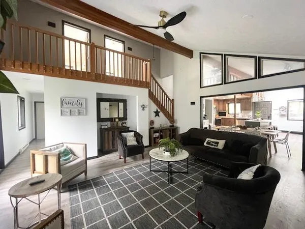 a living room with furniture and wooden floor