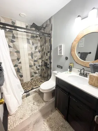 a bathroom with a sink toilet and shower
