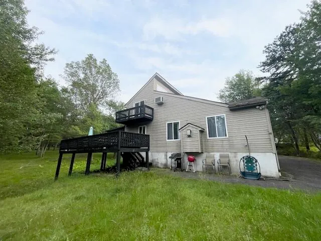 a backyard of a house with table and chairs