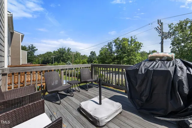 a view of a balcony with wooden floor and outdoor seating