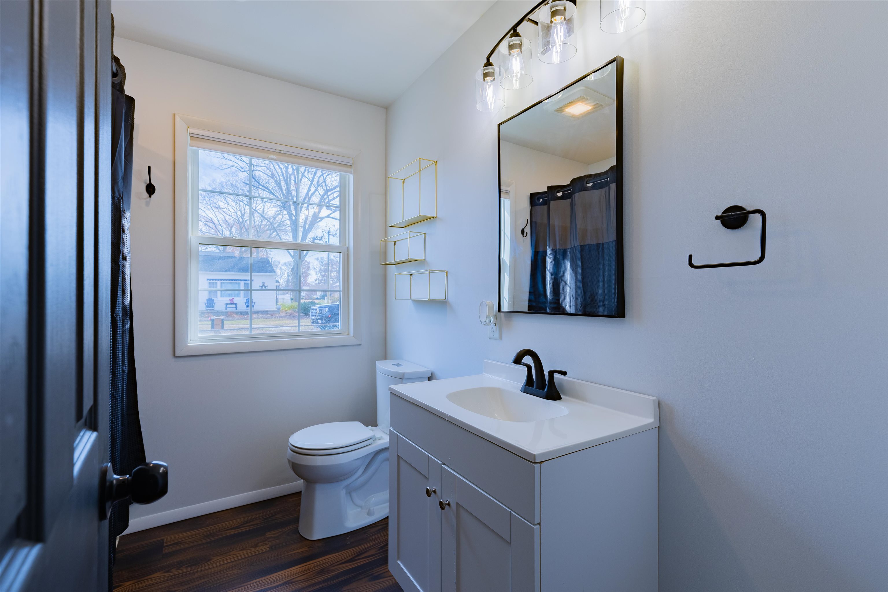 87 Rose Villas, NJ 08251 - Photo 15 of 27 a bathroom with a toilet a sink and mirror