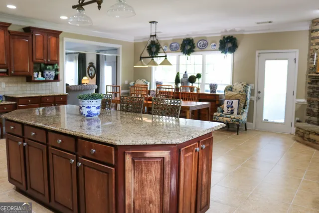 a kitchen with stainless steel appliances granite countertop a sink a stove and a wooden cabinets