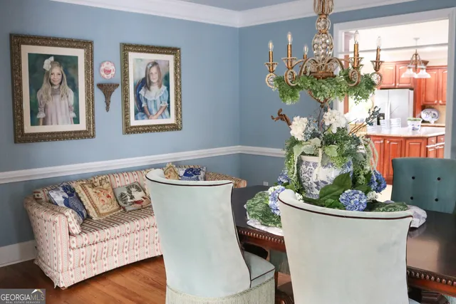 a living room with furniture flowerpot and wooden floor