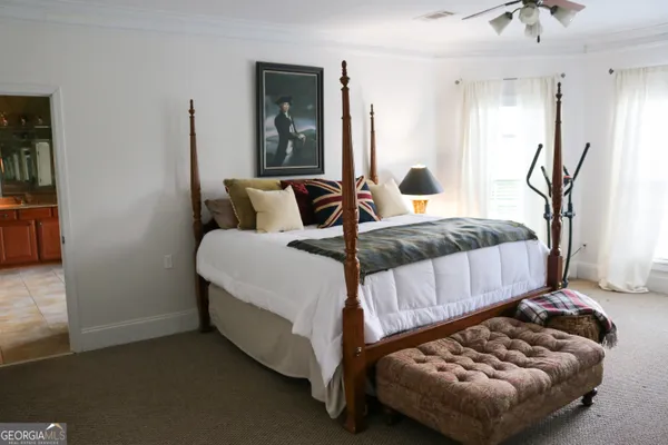 a bedroom with a bed and window