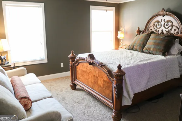 a bedroom with a bed and window