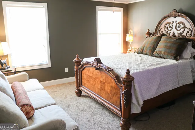 a bedroom with a bed and window
