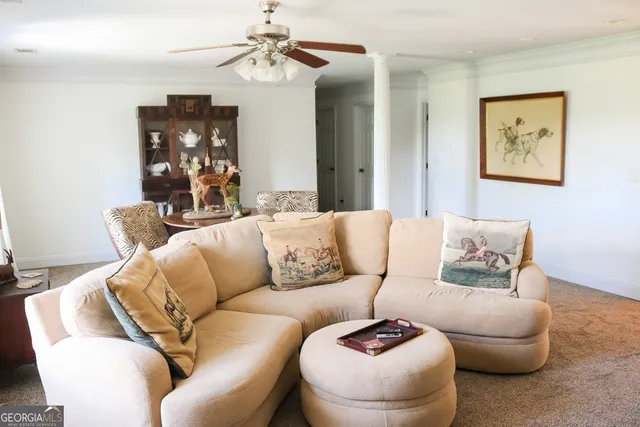 a living room with furniture and a chandelier