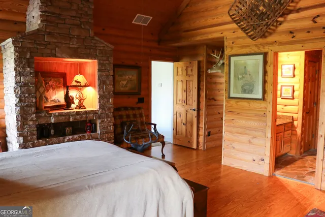 a bedroom with a bed and a large mirror