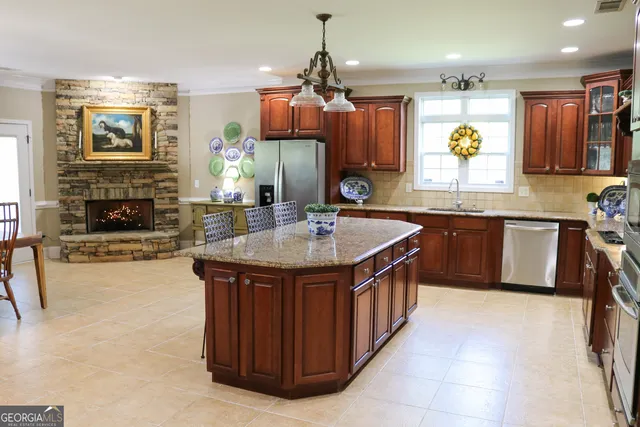 a kitchen with stainless steel appliances granite countertop a sink dishwasher stove and oven