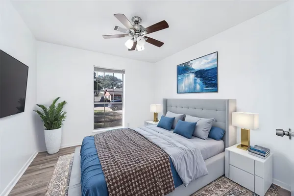 a bedroom with a large bed and a window