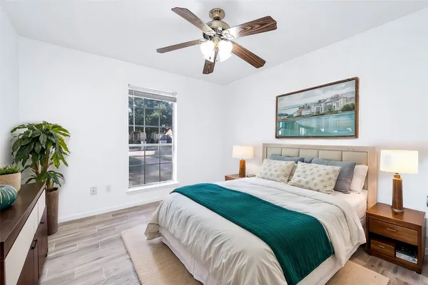 a bedroom with bed and a large window
