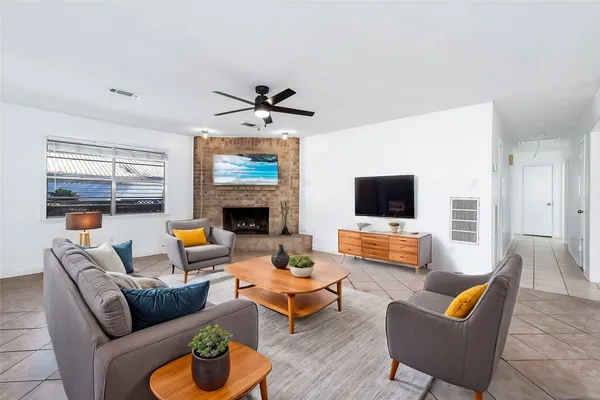 a living room with furniture fireplace and a flat screen tv