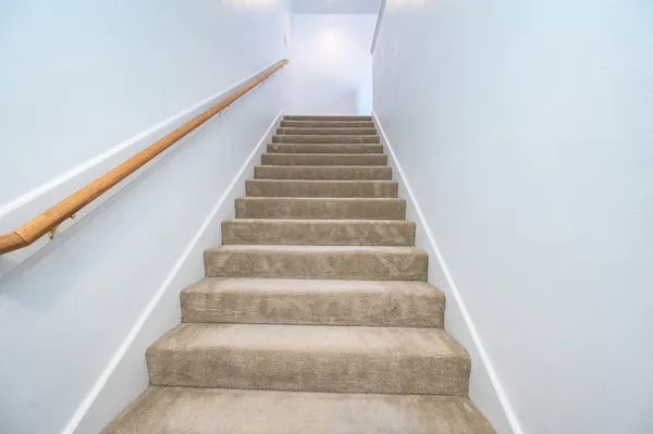 a view of staircase with white walls