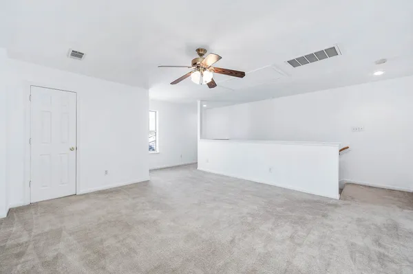 a view of a room with ceiling fan