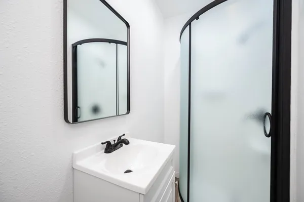 a bathroom with a sink and mirror