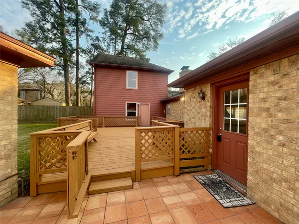 a view of a house with backyard and wooden fence