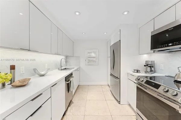 a kitchen with stainless steel appliances granite countertop a sink and a stove