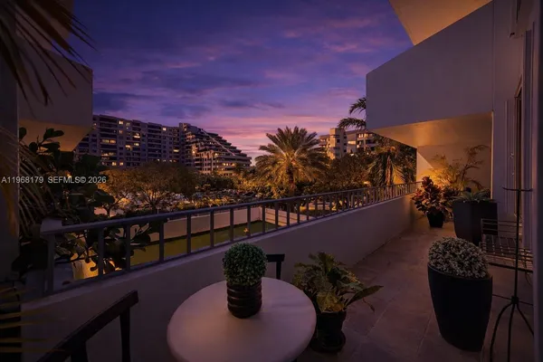 a bedroom with a bed and large windows