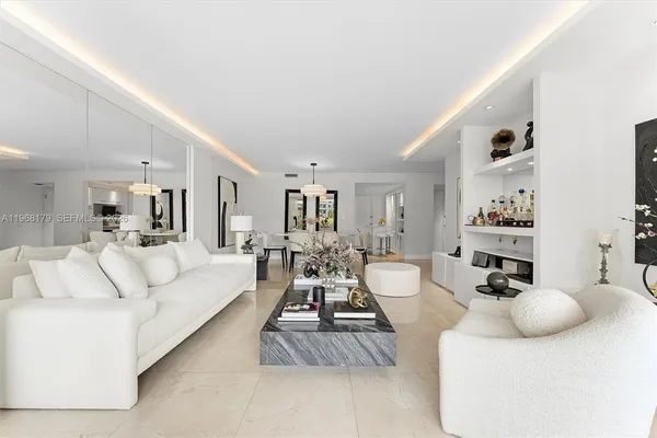 a living room with furniture and a large mirror