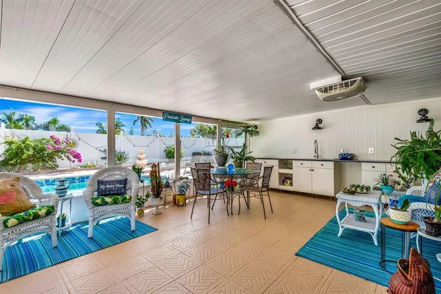 a living room with lots of furniture and a potted plant
