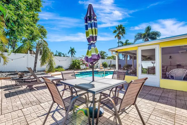 a view of a patio with a table and chairs