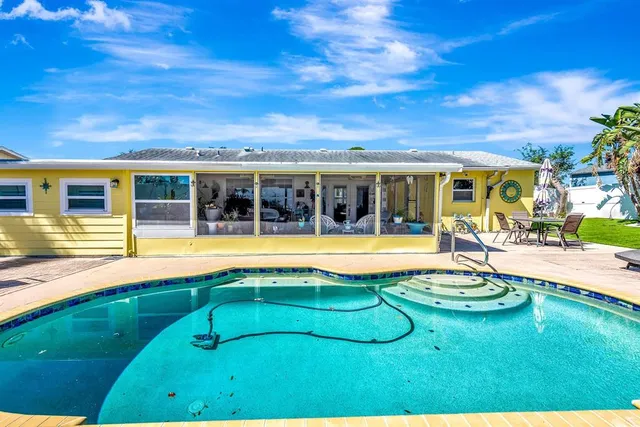 a view of a swimming pool with an outdoor seating