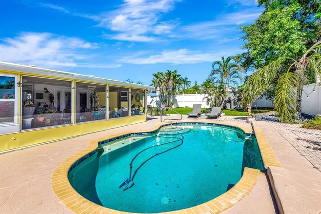 a view of a swimming pool with an outdoor seating