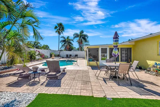a view of a patio with table and chairs and potted plants
