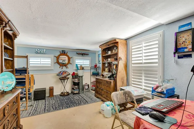 a bedroom with furniture and a window