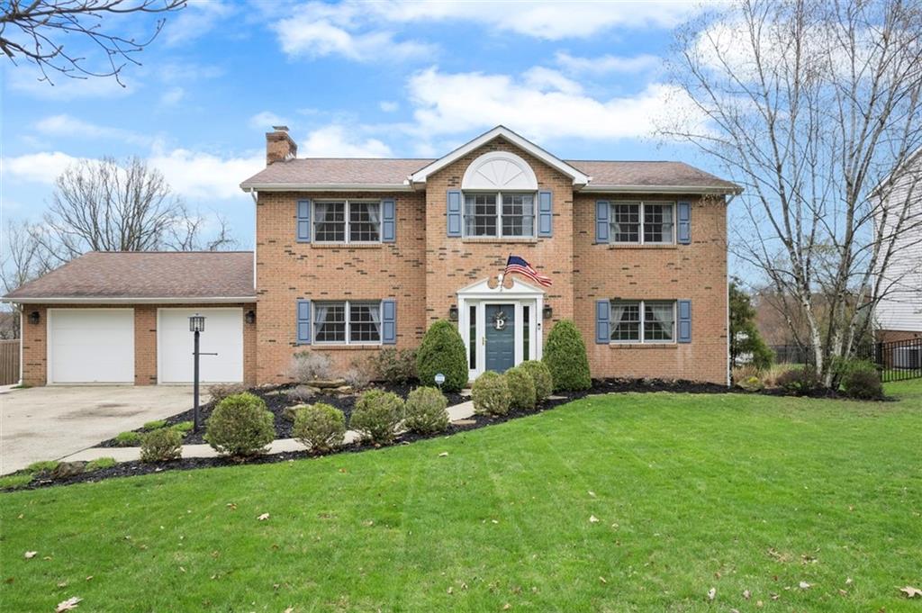a front view of a house with a garden and plants