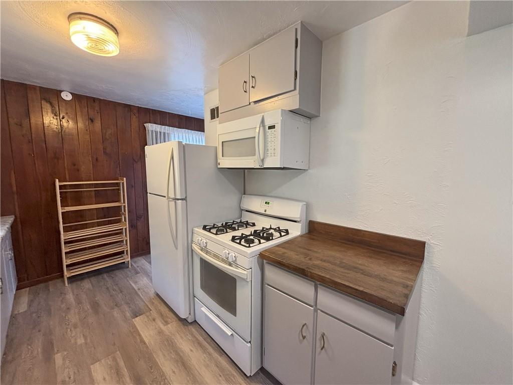 3395 Logan Ferry Road Murrysville, PA 15668 - Photo 11 of 36 a kitchen with white cabinets and white appliances