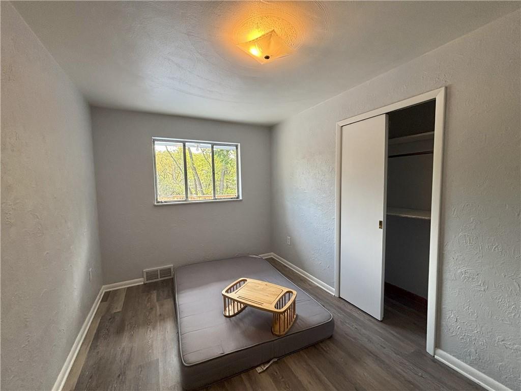 3395 Logan Ferry Road Murrysville, PA 15668 - Photo 19 of 36 an empty room with wooden floor cabinet and windows