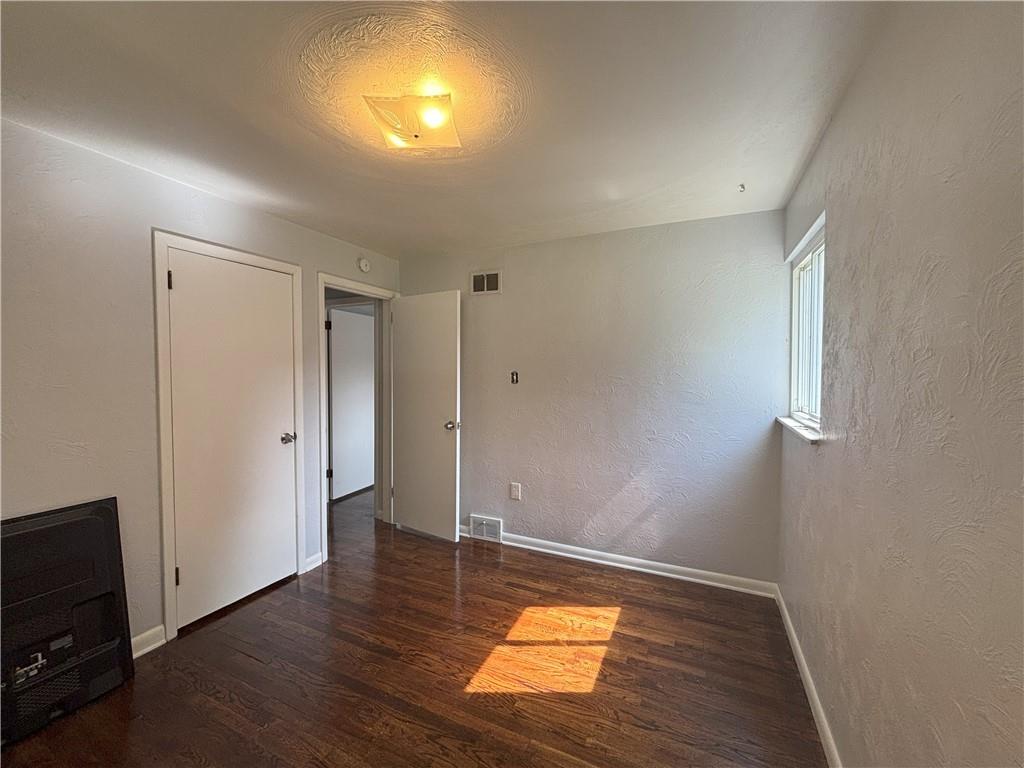 3395 Logan Ferry Road Murrysville, PA 15668 - Photo 30 of 36 an empty room with wooden floor and windows