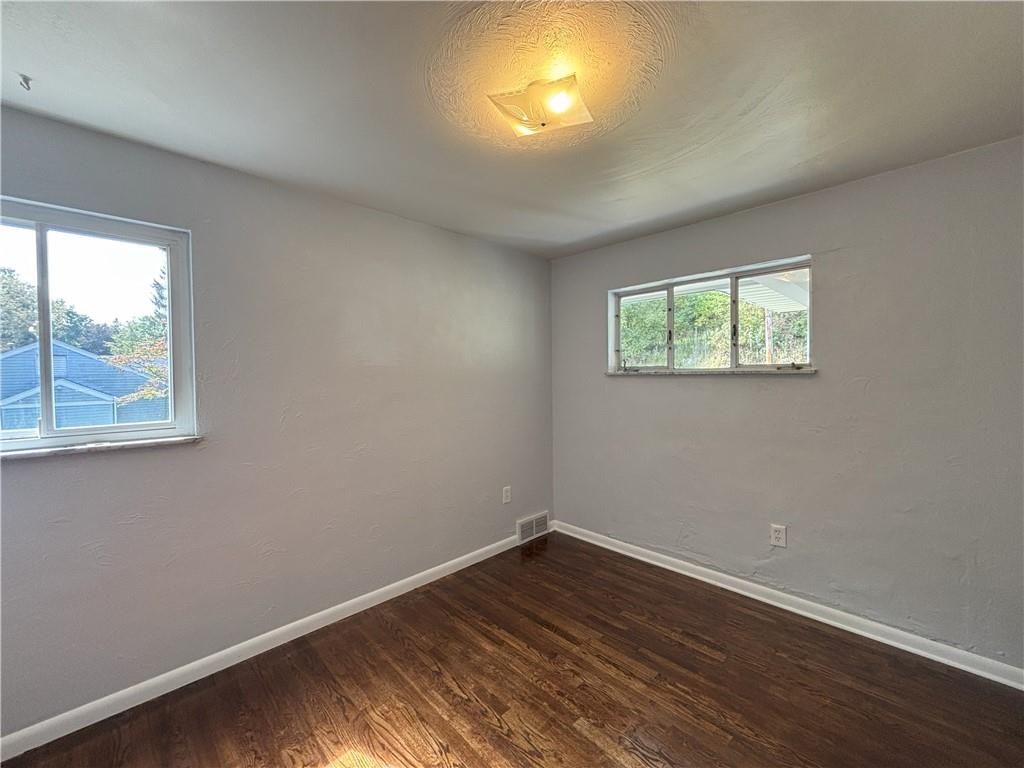 3395 Logan Ferry Road Murrysville, PA 15668 - Photo 32 of 36 an empty room with wooden floor and windows