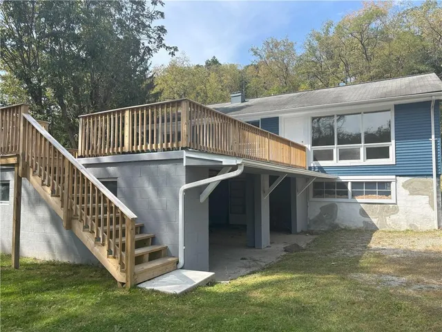 a view of a house with backyard and deck